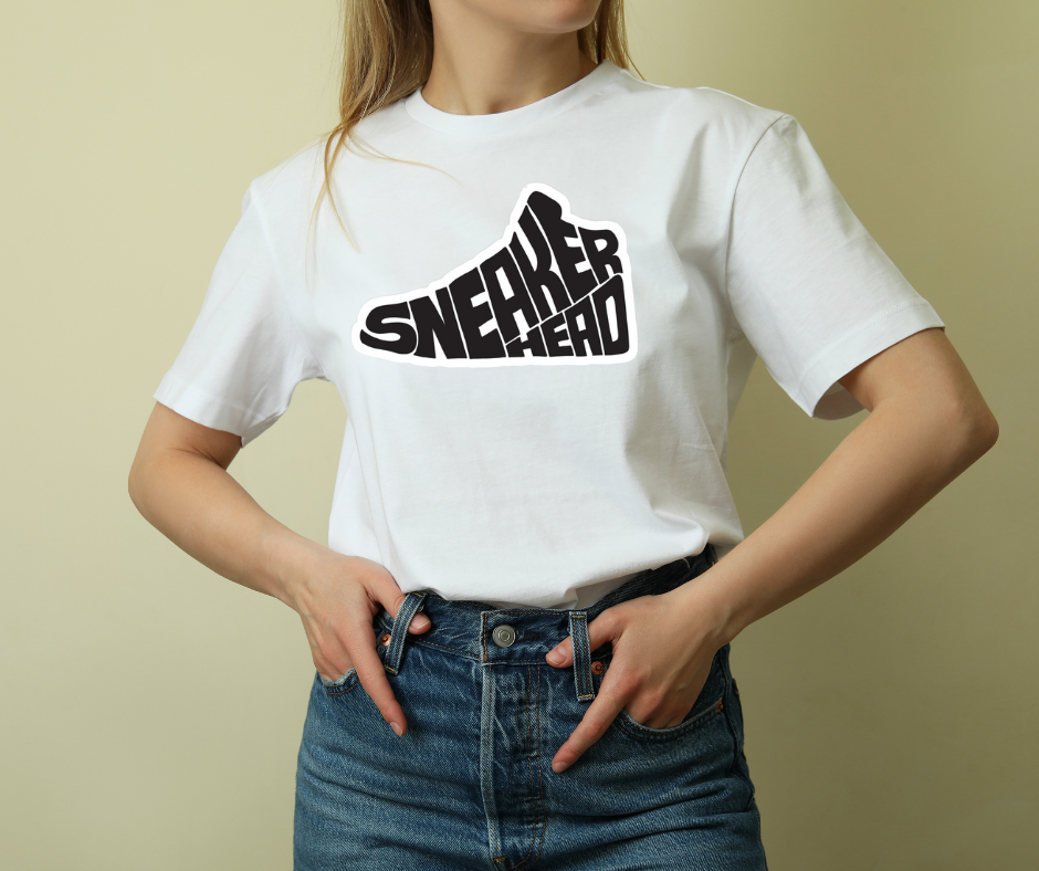 Person wearing a white t-shirt with 'SNEAKER HEAD' text design on a beige background