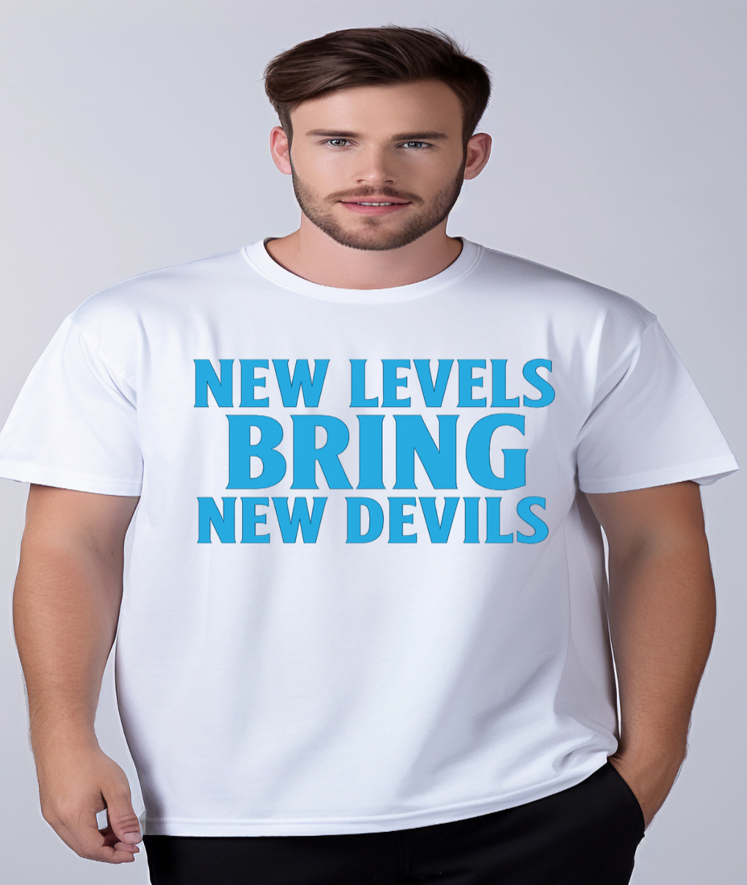 Man wearing a white t-shirt with blue text 'NEW LEVELS BRING NEW DEVILS' on a plain background
