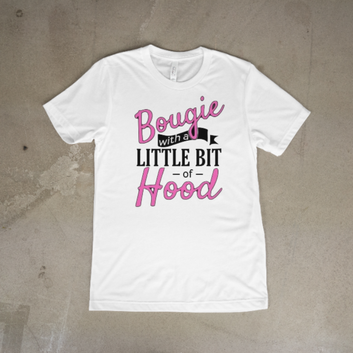 White t-shirt with text design on a textured surface