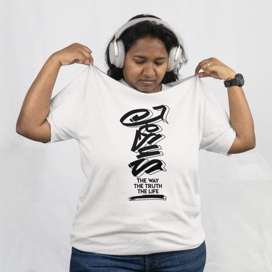 Person wearing a white t-shirt with black text and graphics, holding it up to show the design.