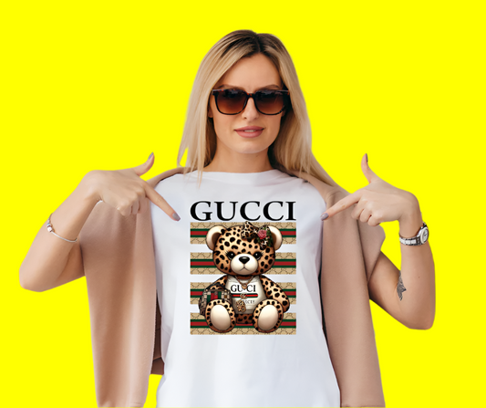 Gucci women’s tee with brown leopard teddy bear graphic, luxury shirt featuring iconic bear design with bold GG logo
