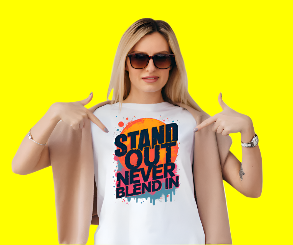 Bold 'Stand Out, Never Blend In' motivational tee for women, vibrant colors and empowering quote."