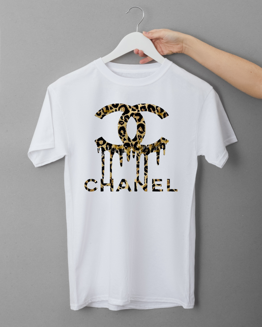 White t-shirt with leopard print Chanel logo on a hanger against a gray background