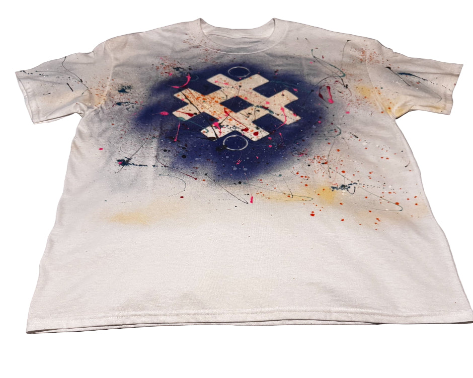 White t-shirt with a colorful design on a gray surface