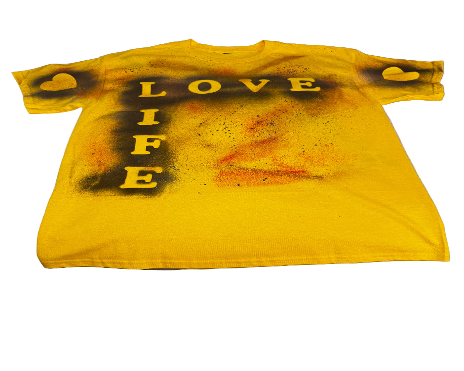 Yellow tank top with black text on a textured surface