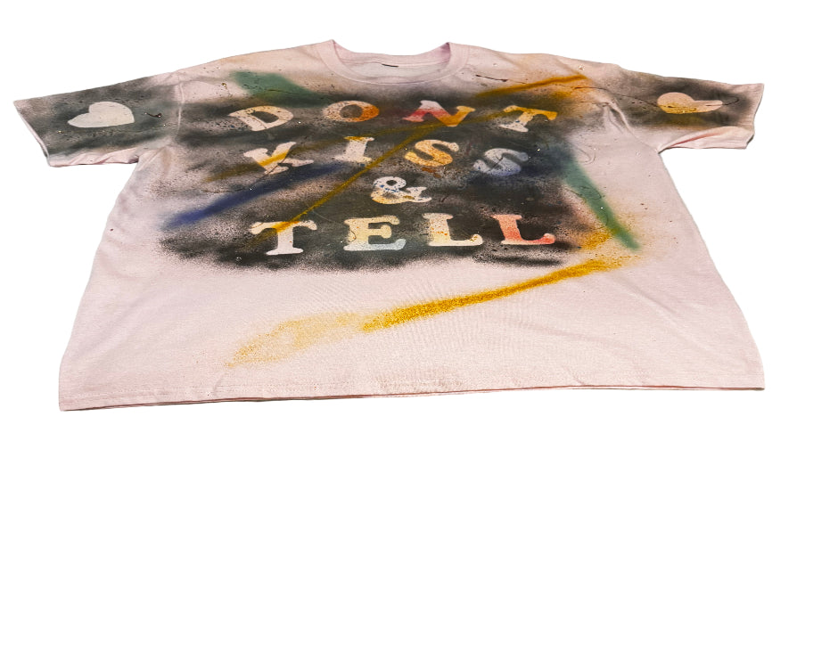 T-shirt with spray paint design on a textured surface