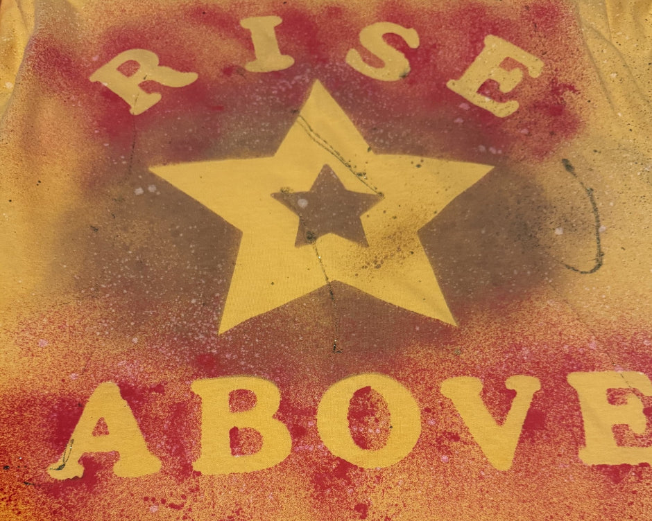 Yellow star with 'RISE ABOVE' text on a textured red and yellow background