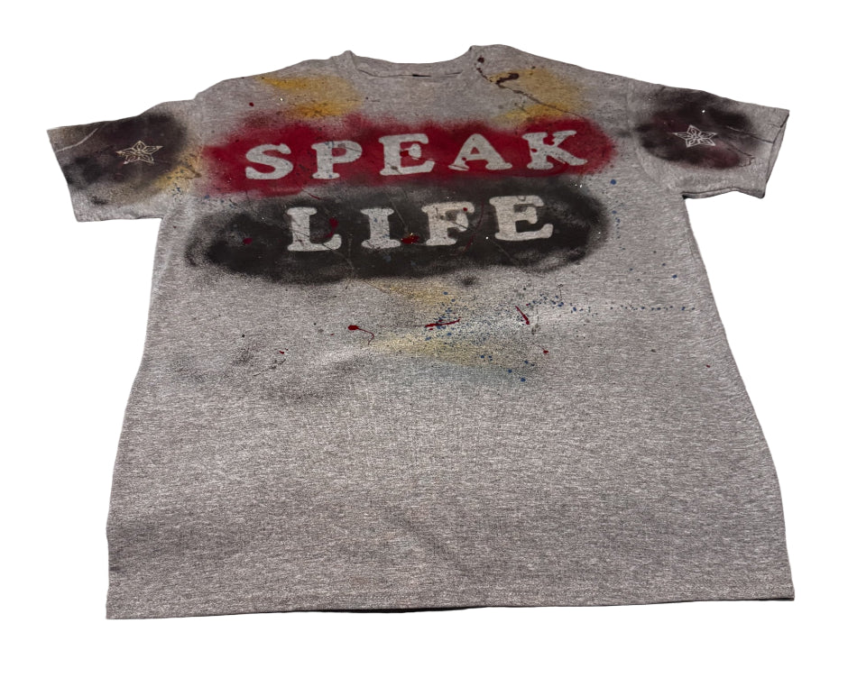 Gray t-shirt with 'SPEAK LIFE' text on a textured surface