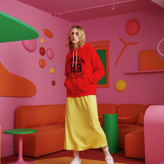 Person wearing a red hoodie and yellow skirt in a colorful room with pink walls and orange furniture.