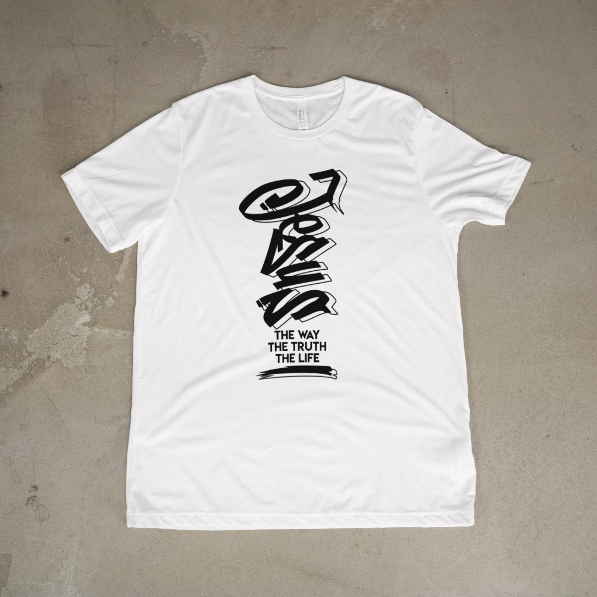 White t-shirt with black graphic design on a textured surface