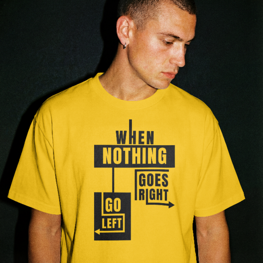 Man wearing a yellow t-shirt with black text and graphics on a dark background