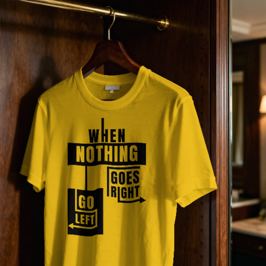 Yellow t-shirt with black text design hanging on a wooden door.