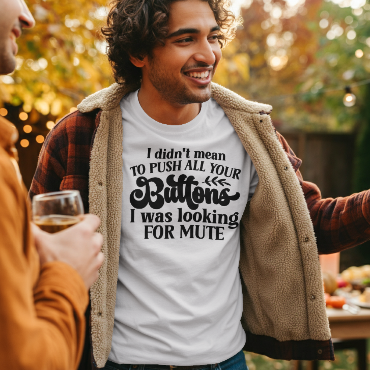Man wearing a white t-shirt with humorous text, standing outdoors with another person.