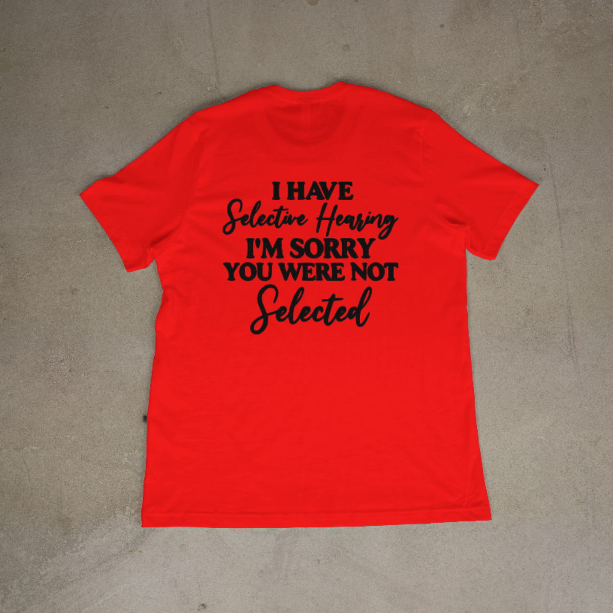Red t-shirt with black text on a gray surface