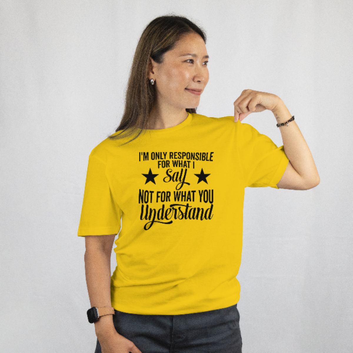 Person wearing a yellow t-shirt with a black text design on a plain background