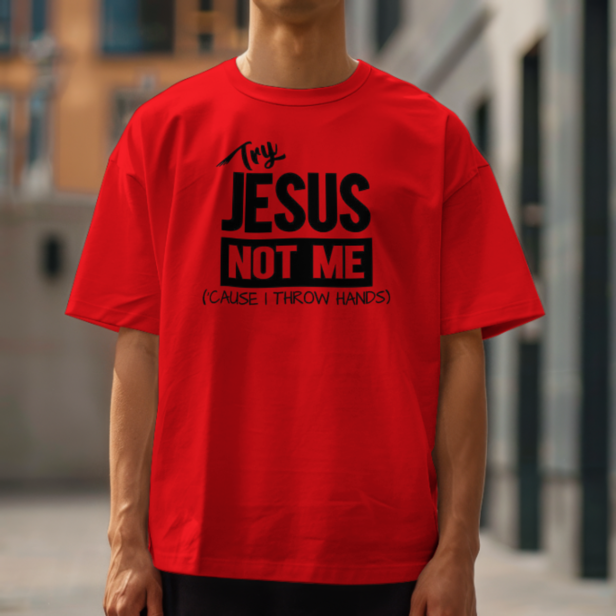 Person wearing a red t-shirt with black text in an urban setting