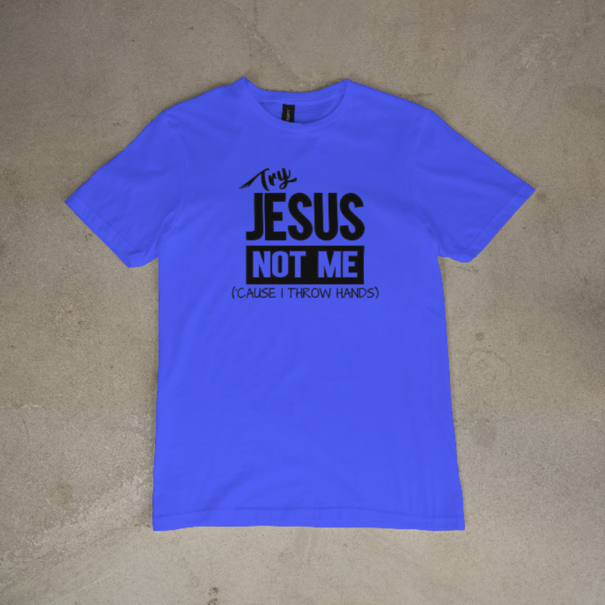 Blue t-shirt with black text on a beige surface