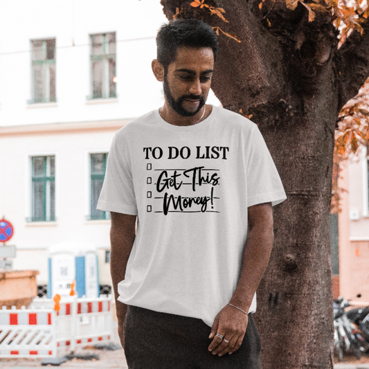 Man wearing a white t-shirt with 'To Do List: Get This Money!' text in an urban setting.