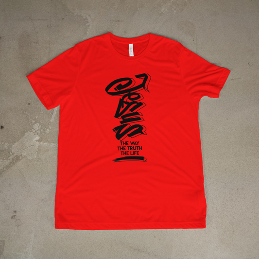 Red t-shirt with black graphic design on a concrete floor