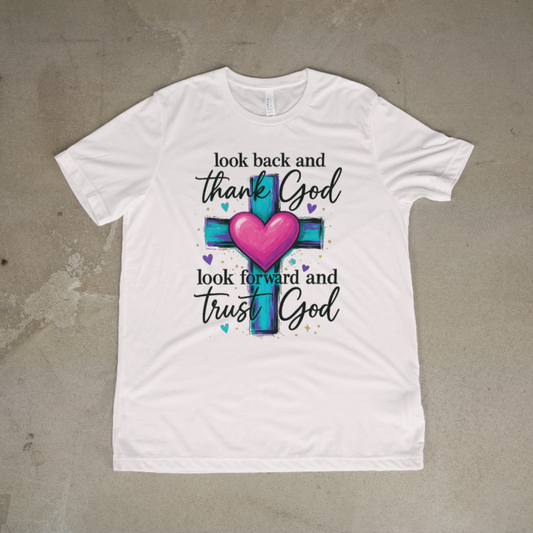 White t-shirt with a cross and heart design on a textured surface