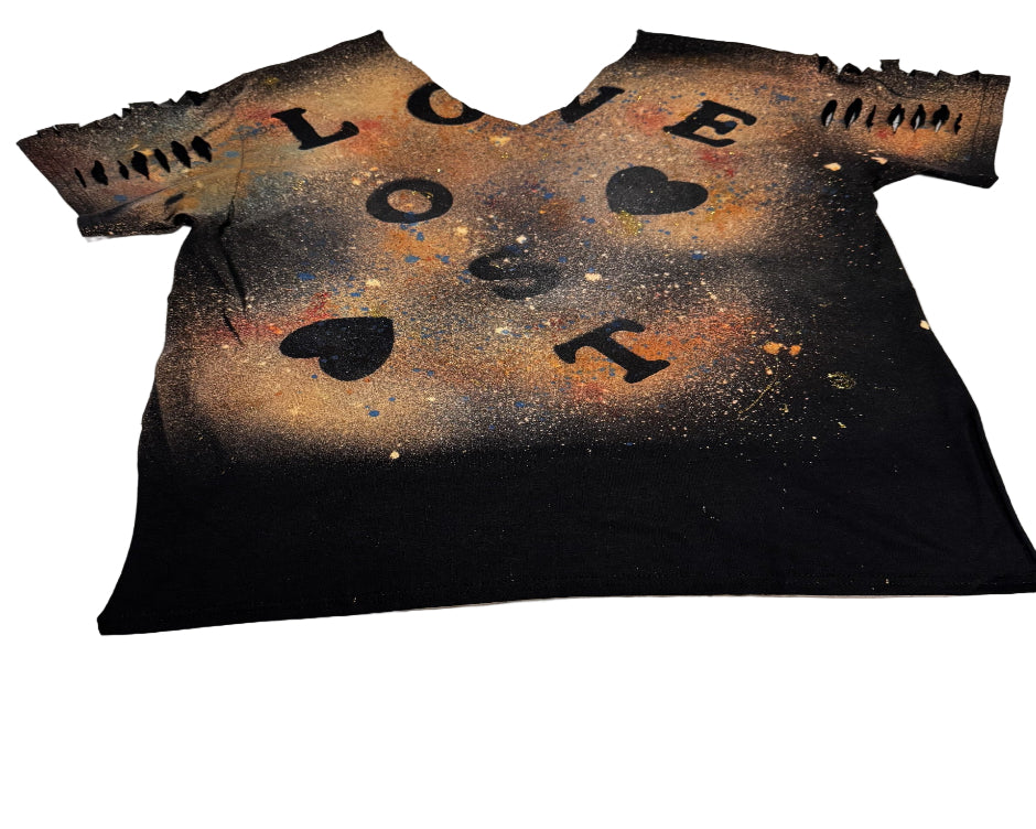 Black t-shirt with 'LOVE' and heart designs on a white surface