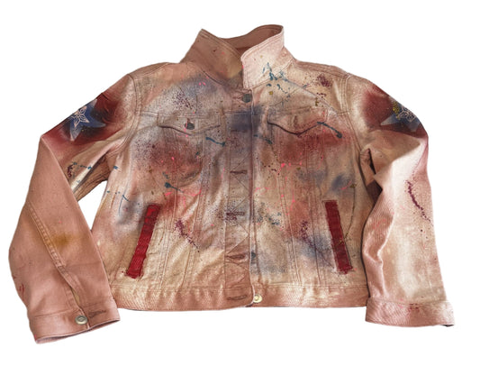 Pink leather jacket with artistic paint splashes on a light gray surface