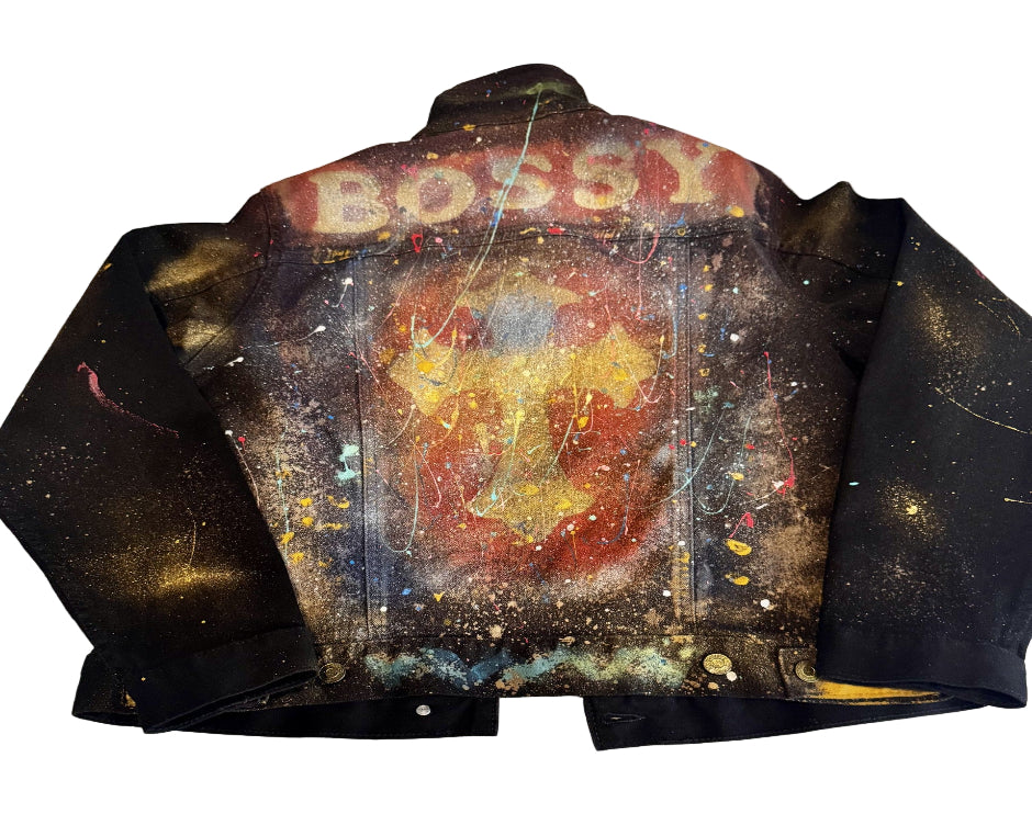 Black leather jacket with colorful abstract design and 'BOSS' text on a white surface